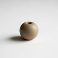 Spherical ceramic object with a smooth texture rests on a flat Royalty Free Stock Photo