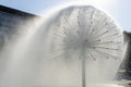 Spherical fountain spraying water in city park. Transparent splash in form ball. Royalty Free Stock Photo