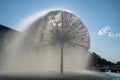 Spherical fountain spraying water in city park. Transparent splash in form ball. Royalty Free Stock Photo