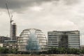 Spherical and futuristic City Hall building view across Thames river on a cloudy day