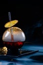 Spherical glass with smoke and alcohol. Caramelized Lemon Slices. Smoke on a black background. Royalty Free Stock Photo