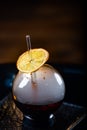 Spherical glass with smoke and alcohol. Caramelized Lemon Slices. Smoke on a black background Royalty Free Stock Photo