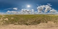 spherical 360 hdri panorama among dry grass farming field with clouds on blue sky in equirectangular seamless projection, use as Royalty Free Stock Photo