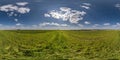 spherical 360 hdri panorama among green grass farming field with clouds on blue sky in equirectangular seamless projection, use as Royalty Free Stock Photo