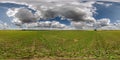 spherical 360 hdri panorama among green grass farming field with storm clouds on blue sky in equirectangular seamless projection, Royalty Free Stock Photo