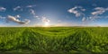 spherical 360 hdri panorama among green grass farming field with storm clouds on blue sky in equirectangular seamless projection, Royalty Free Stock Photo