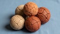 Spherical objects with a cracked surface texture are arranged on a blue fabric Royalty Free Stock Photo