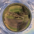 Spherical panorama from aerial photographs of historical houses covered with reed within meadows, fields and woods