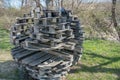 Spherical structure of wooden pallets and planks, symbolizing globe on background of trees. Second life project for recyclables. Royalty Free Stock Photo