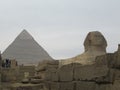 Sphinx in front of Pyramid in Cairo. Giza pyramid complex Royalty Free Stock Photo