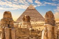 Sphinx of Giza and Colossals by the Khafre Pyramid, Cairo, Egypt Royalty Free Stock Photo