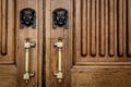 Sphinx heads entrance on wooden door Royalty Free Stock Photo