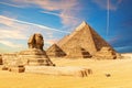 The Sphinx next to the Pyramids in the sands of Giza desert, Egypt Royalty Free Stock Photo