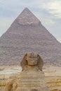 Sphinx sculpture and the Cheops pyramid in Giza Egypt Royalty Free Stock Photo