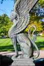 Sphinx statue side view on bright summer day with sunny garden in background, Muncie Indiana