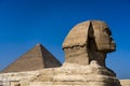 Sphinx with view  of the Great Pyramids of Giza, Cairo, Egypt Royalty Free Stock Photo