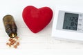 Sphygmomanometer, heart and pills on a sheet of EKG Royalty Free Stock Photo