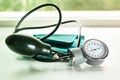 Sphygmomanometer on the working table of a cardiologist. Green tonometer for measuring blood pressure.