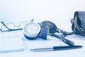 Sphygmomanometer on the working table of a cardiologist. Tonometer, electrocardiogram and notepad with pen for records.