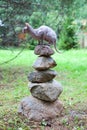 Sphynx cat sitting on top of stone pyramid in forest Royalty Free Stock Photo