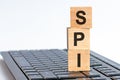 SPI word on wooden block sign on a keyboard Royalty Free Stock Photo
