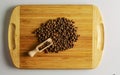 Spice allspice peas. Aromatic spice for food. Background of dried seeds allspice peas on a wooden kitchen board with a measuring Royalty Free Stock Photo