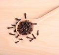 Spice cloves in spoon on wood background ; spice is herb for health and  Aromatherapy Royalty Free Stock Photo