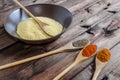 Spice on spoon with bowl of couscous Royalty Free Stock Photo