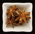 Spice star anise in a ceramic bowl. Royalty Free Stock Photo