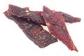 Spiced beef jerky pieces isolated on white background. Portion of sliced and dried meat Royalty Free Stock Photo