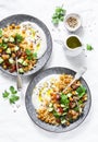 Spiced chickpeas and couscous with shepherd`s salad and greek yogurt on a white background, top view