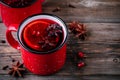 Spiced Pomegranate Apple Cider Mulled Wine Sangria in red mugs on wooden background. Royalty Free Stock Photo