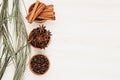 Spices - aniseed, cinnamon, cloves and herbs in wooden bowls on a wood white background.
