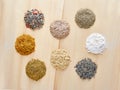Spices circles 8 pieces on a wooden background. Garlic, coriander, for meat, for salad, red pepper, black pepper