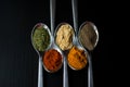 Spices colored in silver spoons Royalty Free Stock Photo