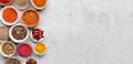 Spices and condiments in bowls on grey background Royalty Free Stock Photo