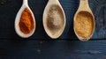 Spices and condiments in wooden spoons, on a dark wooden background. Paprika, curcuma, turmeric, pepper