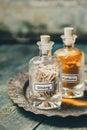 Spices-ginseng and turmeric- in bottles on rustic background, close up