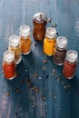 Spices in glass bottles over rustic wooden background Royalty Free Stock Photo