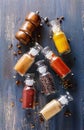 Spices in glass bottles over rustic wooden background Royalty Free Stock Photo