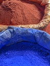 Spices and herbs being sold on street at Morocco traditional market in blue and red