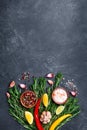 Spices and herbs on black stone table top view. Ingredients for cooking. Food background.