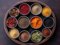 Spices and herbs in metal bowls over grunge background. Top view