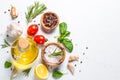 Spices, herbs and olive oil over white stone table. Royalty Free Stock Photo