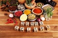 Spices and herbs on table. Food and cuisine ingredients with pepper and spices herbs sign with wooden cubes