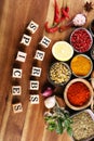 Spices and herbs on table. Food and cuisine ingredients with pepper and spices herbs sign with wooden cubes