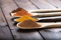 Spices and herbs in wood spoons over wooden background Royalty Free Stock Photo