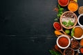 Spices and herbs on a wooden board. Pepper, salt, paprika, basil, turmeric. On a black wooden chalkboard. Royalty Free Stock Photo