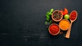 Spices and herbs on a wooden board. Pepper, salt, paprika, basil, turmeric. On a black wooden chalkboard. Royalty Free Stock Photo