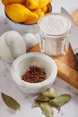 Spices in marble mortar and heap of bay leaves, jar with sea salt on cutting board, bowl with lemons Royalty Free Stock Photo